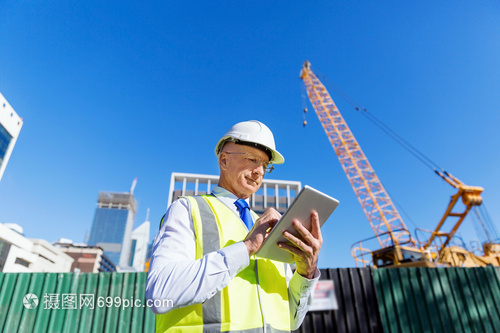 建筑工地的工程师建设者工程师建筑工人施工场景穿着安全背心记事本